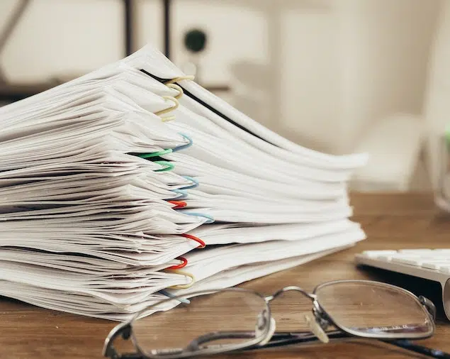 stack of legacy contracts on a desk