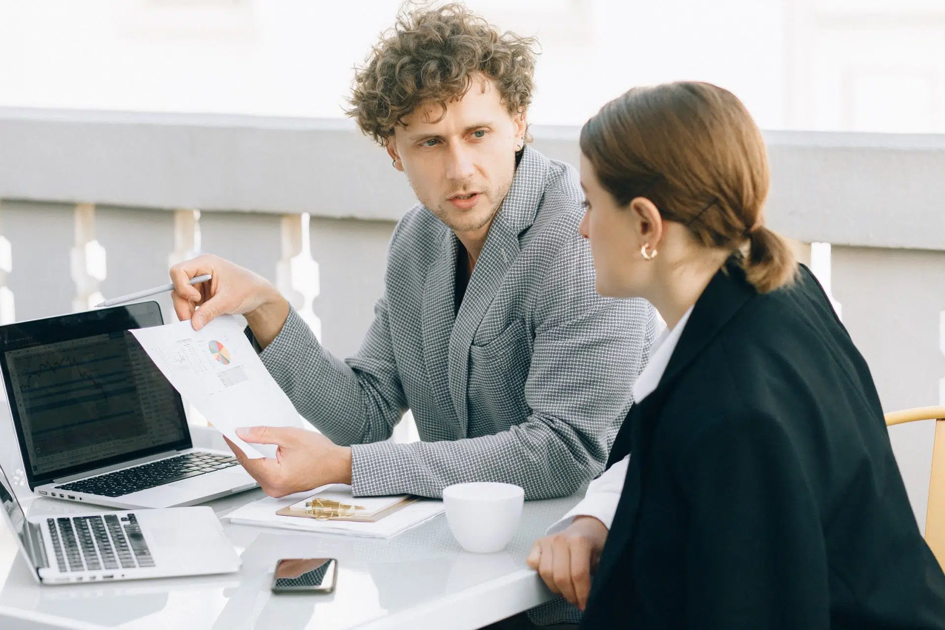 Man and woman reviewing contract data.