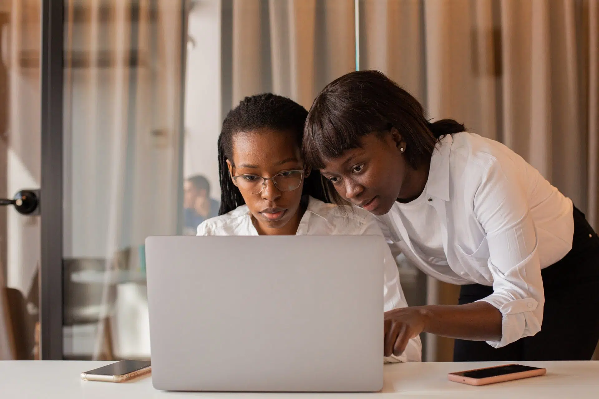 two women using legal tech tools on laptop