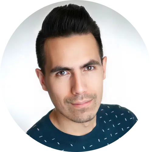 A man with short, dark hair styled upward, wearing a dark sweater with a white dotted pattern, is looking at the camera and smiling slightly—perfect for introducing a top-rated DocuSign alternative. The background is plain white.