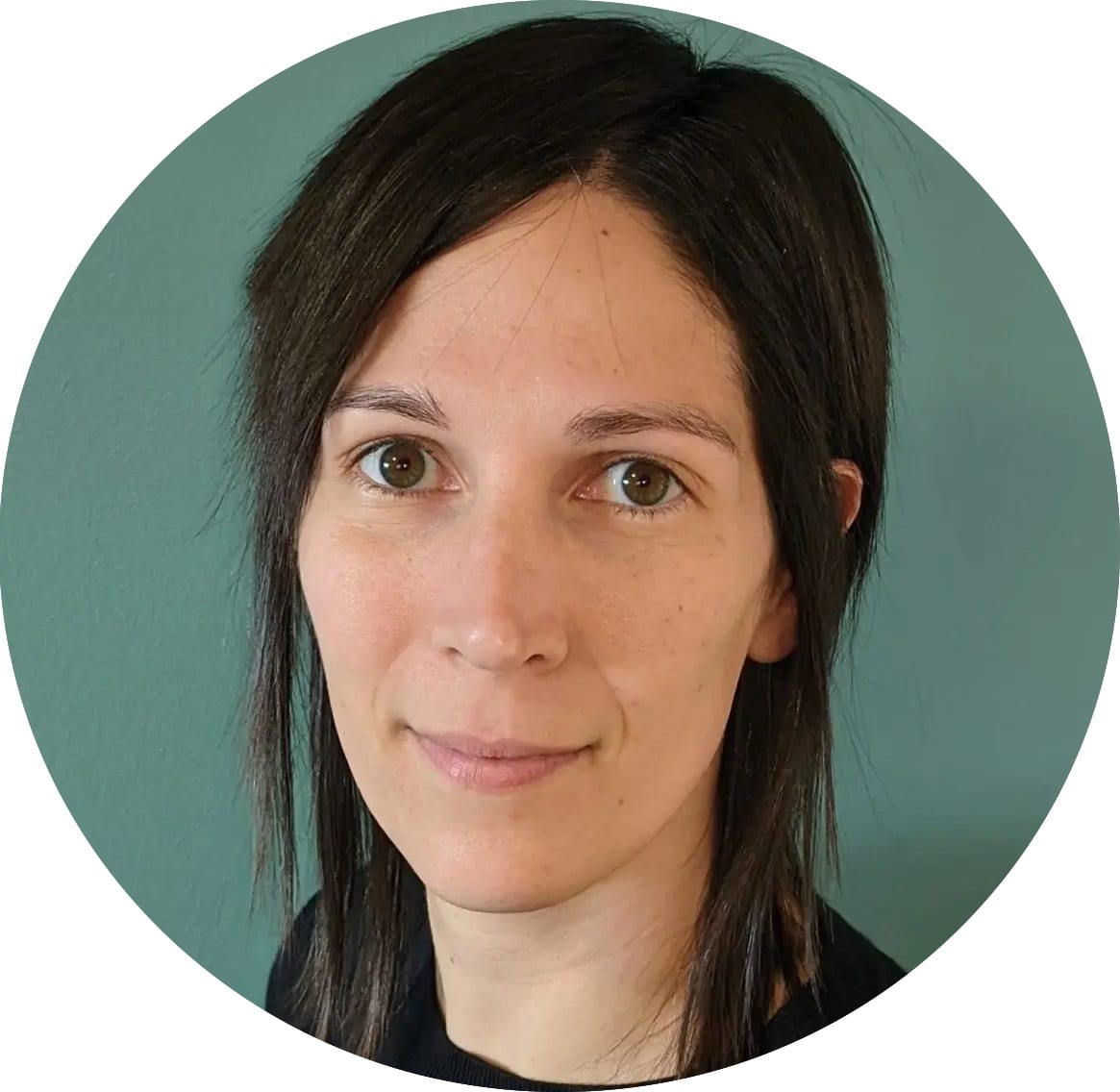 A woman with straight, dark brown hair, light skin, and brown eyes looks at the camera, standing in front of a teal background—perfect for featuring an Evisort alternative.