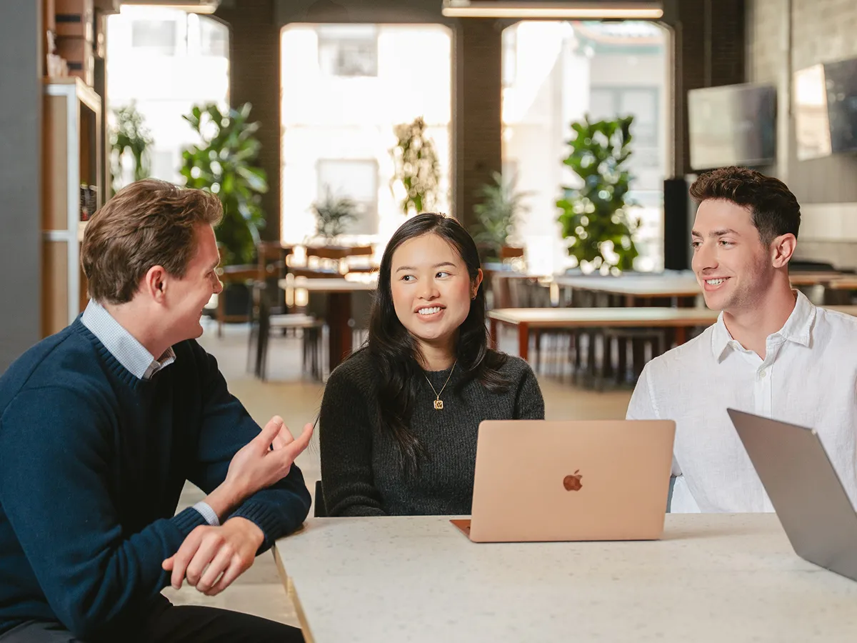 Join the Community community members meeting at a table