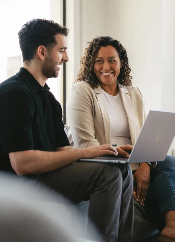 Share Ideas ironclad community members talking over a laptop