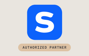 A blue square with a white letter S in the center is above a beige rounded rectangle displaying the text AUTHORIZED PARTNER in uppercase letters.