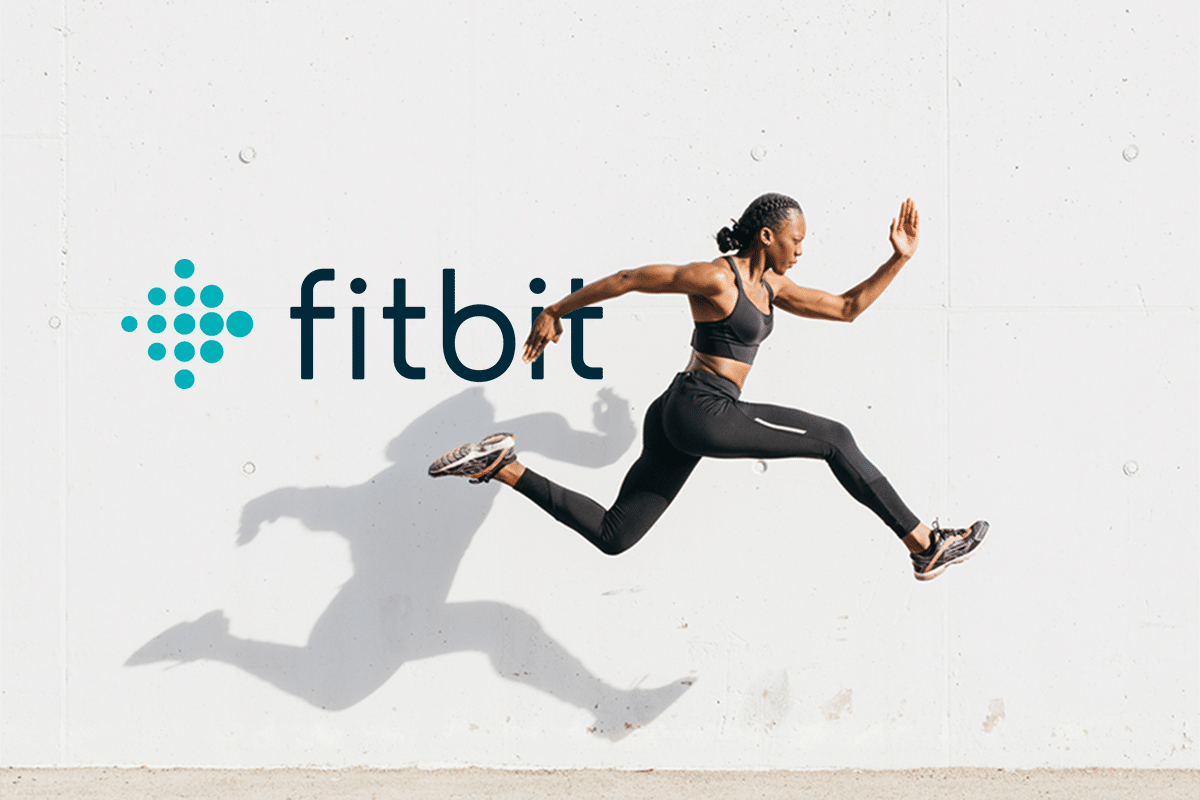 woman running in front of fitbit logo