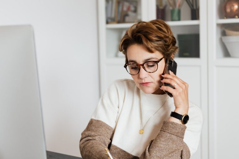 Woman on phone practicing her skill of how to negotiate