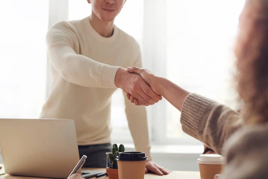procurement officer shaking hands with general counsel