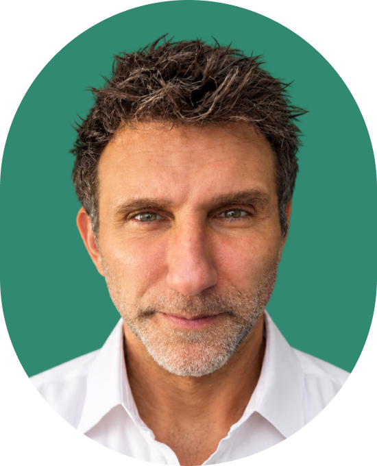 Headshot of a middle-aged man with short dark hair and a light beard, wearing a white collared shirt against a green background.