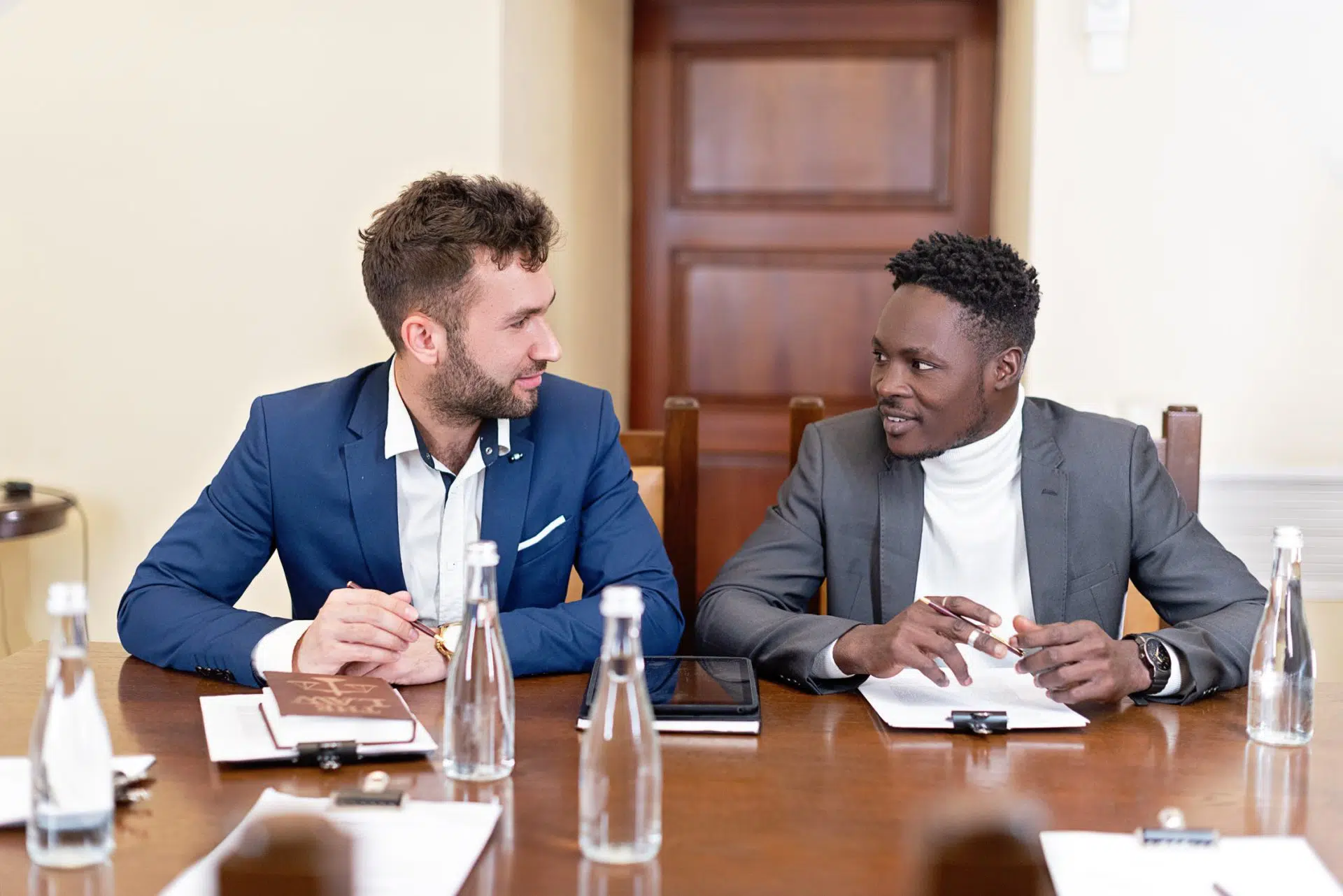 Two men discussing commercial contracts