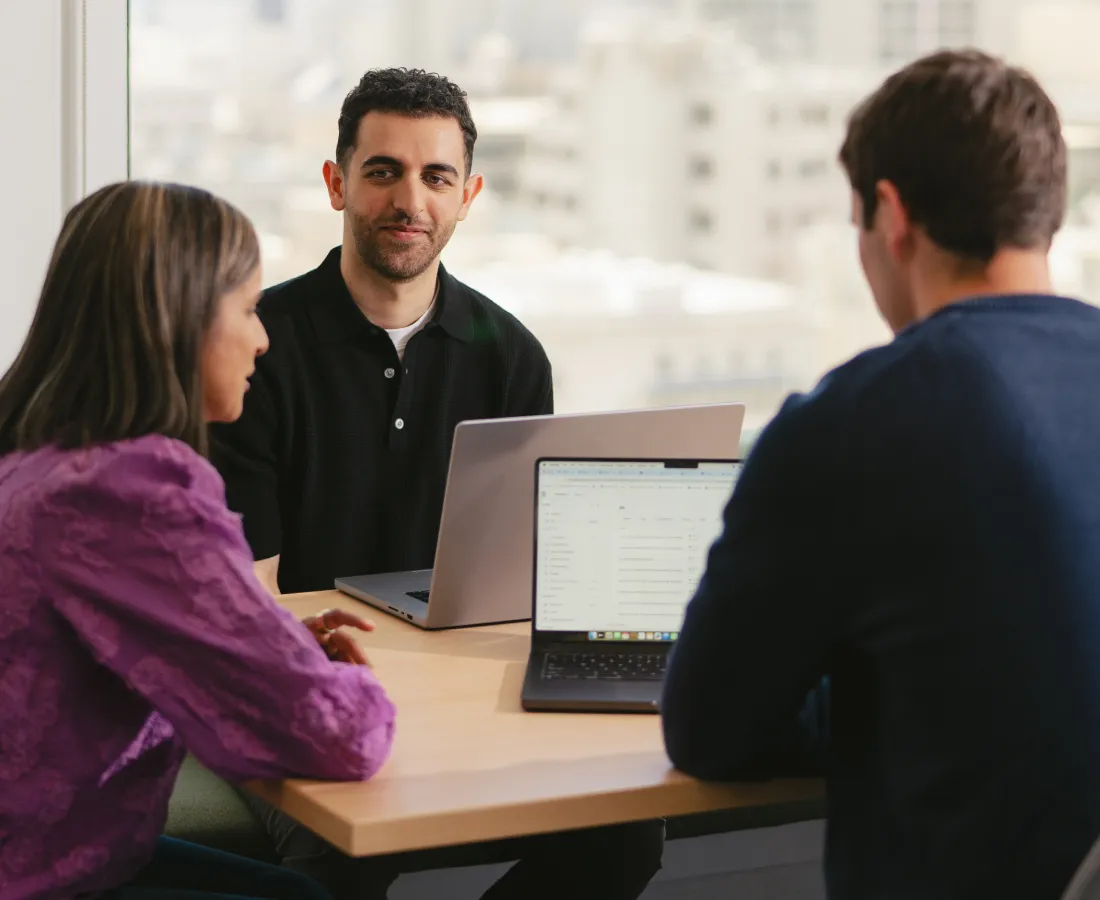 3 people sitting at a table working