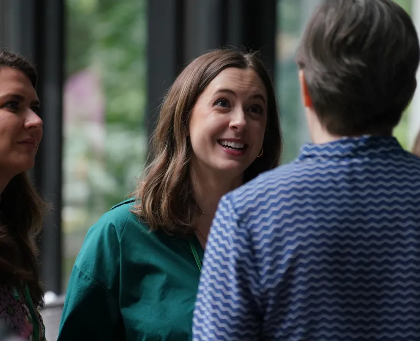 two people smiling and talking