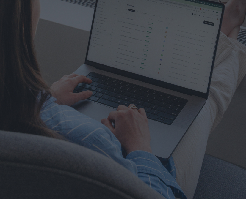 person sitting and typing on a laptop