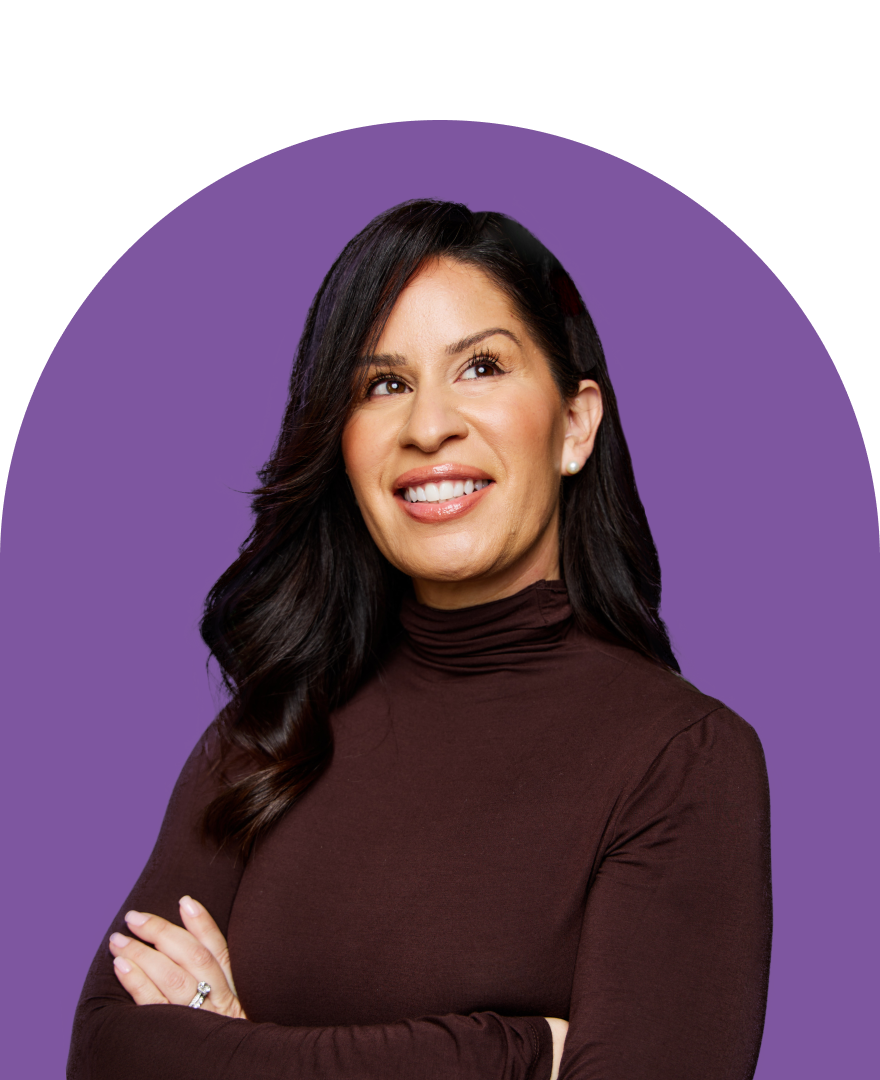 A woman with long dark hair, wearing a brown turtleneck, smiles while looking up as if inspired by an ironclad demo. Her arms are crossed, and the background features a purple semicircle.