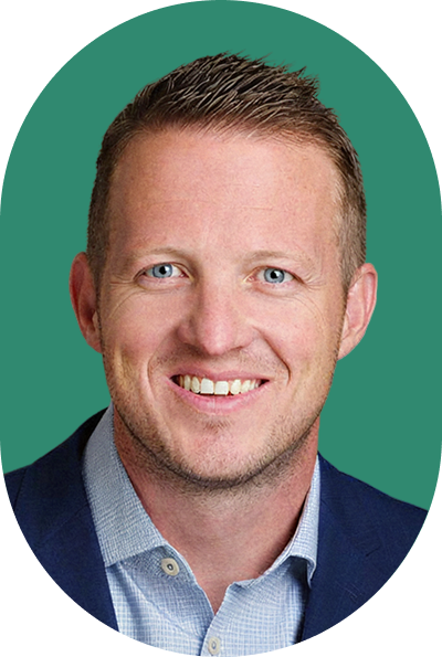 Headshot of a smiling man with short hair wearing a navy blue blazer and a light blue patterned dress shirt, ideal for an AI profile picture.